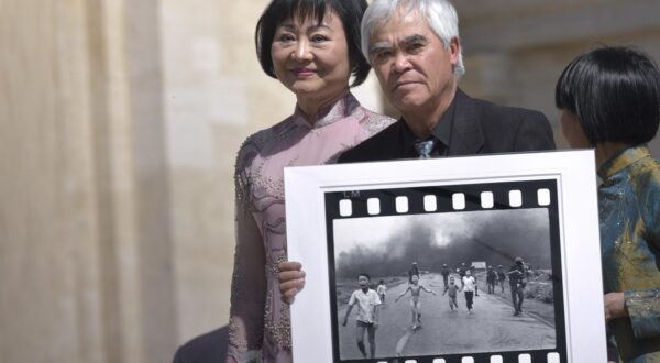 Photographer Nick Ut poses with his 1972 picture The Terror of War, also known as the "Napalm Girl", next to a woman (L) featured in the picture as a child, during the weekly general audience held by Pope Francis at the Vatican, May 11, 2022.