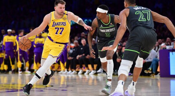 Apr 30, 2025; Los Angeles, California, USA; Los Angeles Lakers guard Luka Doncic (77) moves the ball against Minnesota Timberwolves forward Jaden McDaniels (3) and center Rudy Gobert (27) during the first half in game five of first round for the 2025 NBA Playoffs at Crypto.com Arena. Mandatory Credit: Gary A. Vasquez-Imagn Images Photo: Gary A. Vasquez/REUTERS