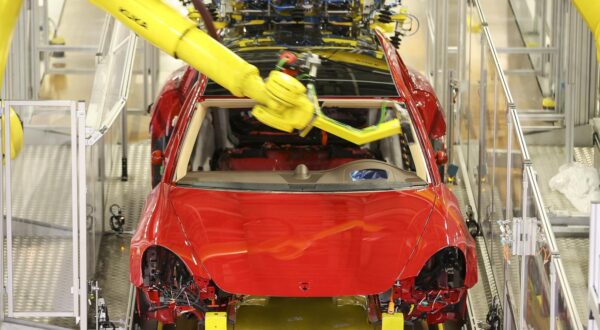 02 February 2022, Saxony, Leipzig: Robots glue the front and rear windows into a Porsche Panamera at the Porsche plant in Leipzig. The automaker will start series production of the E version of its successful Macan model in Leipzig in 2023. Photo: Jan Woitas/dpa-Zentralbild/dpa Photo: Jan Woitas/DPA