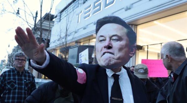 A protestor wearing an Elon Musk mask demonstrates at the Tesla dealership in San Francisco on Wednesday, February 19, 2025. Demonstrations took place all over the country protesting the stopping of public services.  Photo by George Nikitin/UPI Photo via Newscom Photo: GEORGE NIKITIN/NEWSCOM