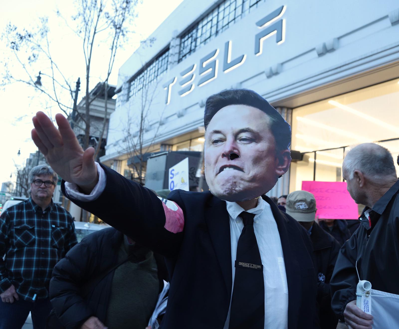 A protestor wearing an Elon Musk mask demonstrates at the Tesla dealership in San Francisco on Wednesday, February 19, 2025. Demonstrations took place all over the country protesting the stopping of public services.  Photo by George Nikitin/UPI Photo via Newscom Photo: GEORGE NIKITIN/NEWSCOM