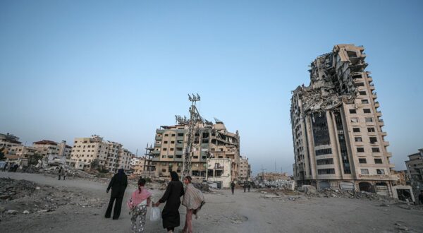 epa12069815 Internally displaced Palestinians walk between destroyed buildings in Gaza City, 02 May 2025. According to the UN, at least 1.9 million people (or nine in ten people) across the Gaza Strip are internally displaced, including people who have been repeatedly displaced. Since October 2023, only about 11 percent of the Gaza Strip has not been placed under Israeli-issued evacuation orders, the UN aid coordination office OCHA said.  EPA/MOHAMMED SABER
