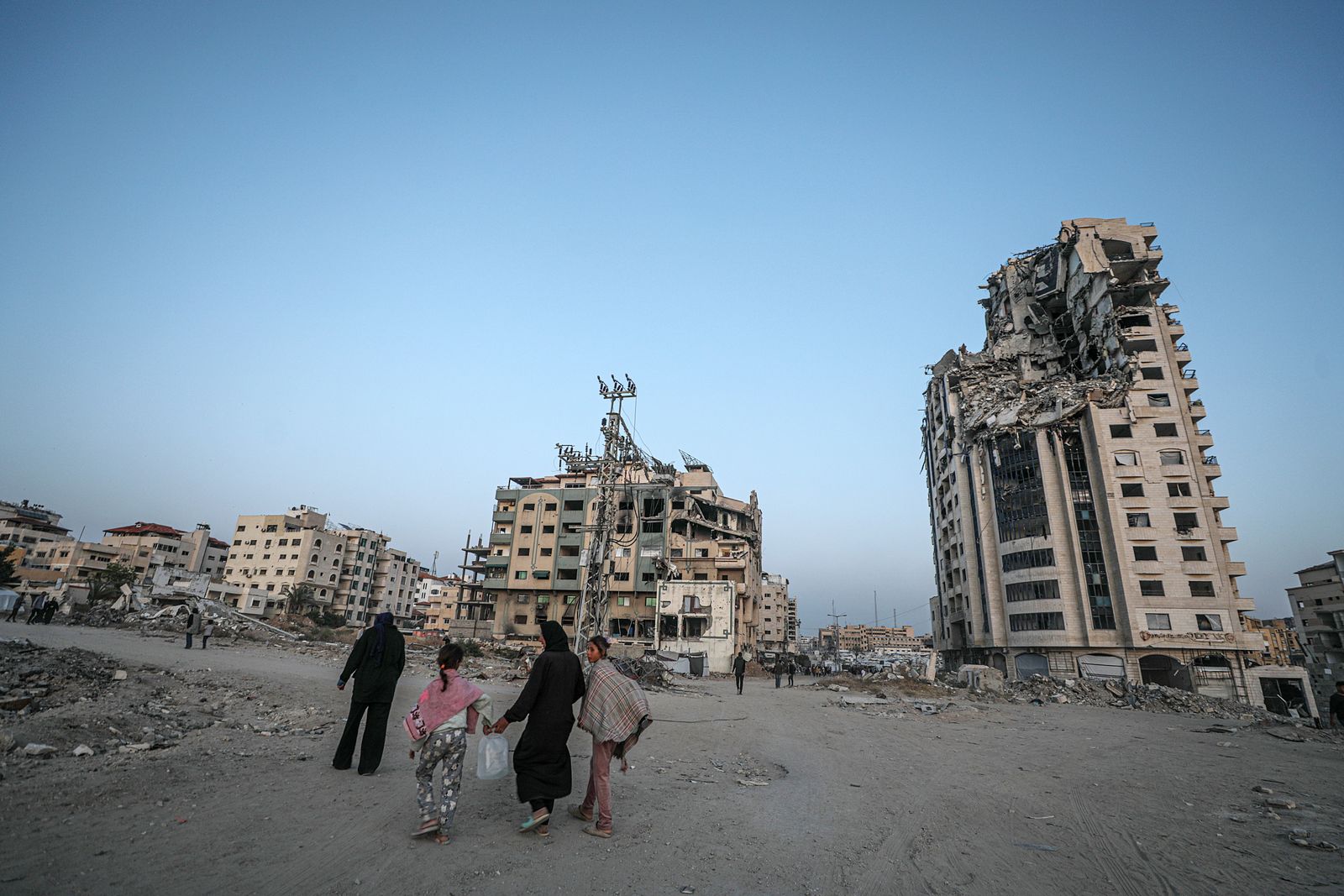 epa12069815 Internally displaced Palestinians walk between destroyed buildings in Gaza City, 02 May 2025. According to the UN, at least 1.9 million people (or nine in ten people) across the Gaza Strip are internally displaced, including people who have been repeatedly displaced. Since October 2023, only about 11 percent of the Gaza Strip has not been placed under Israeli-issued evacuation orders, the UN aid coordination office OCHA said.  EPA/MOHAMMED SABER