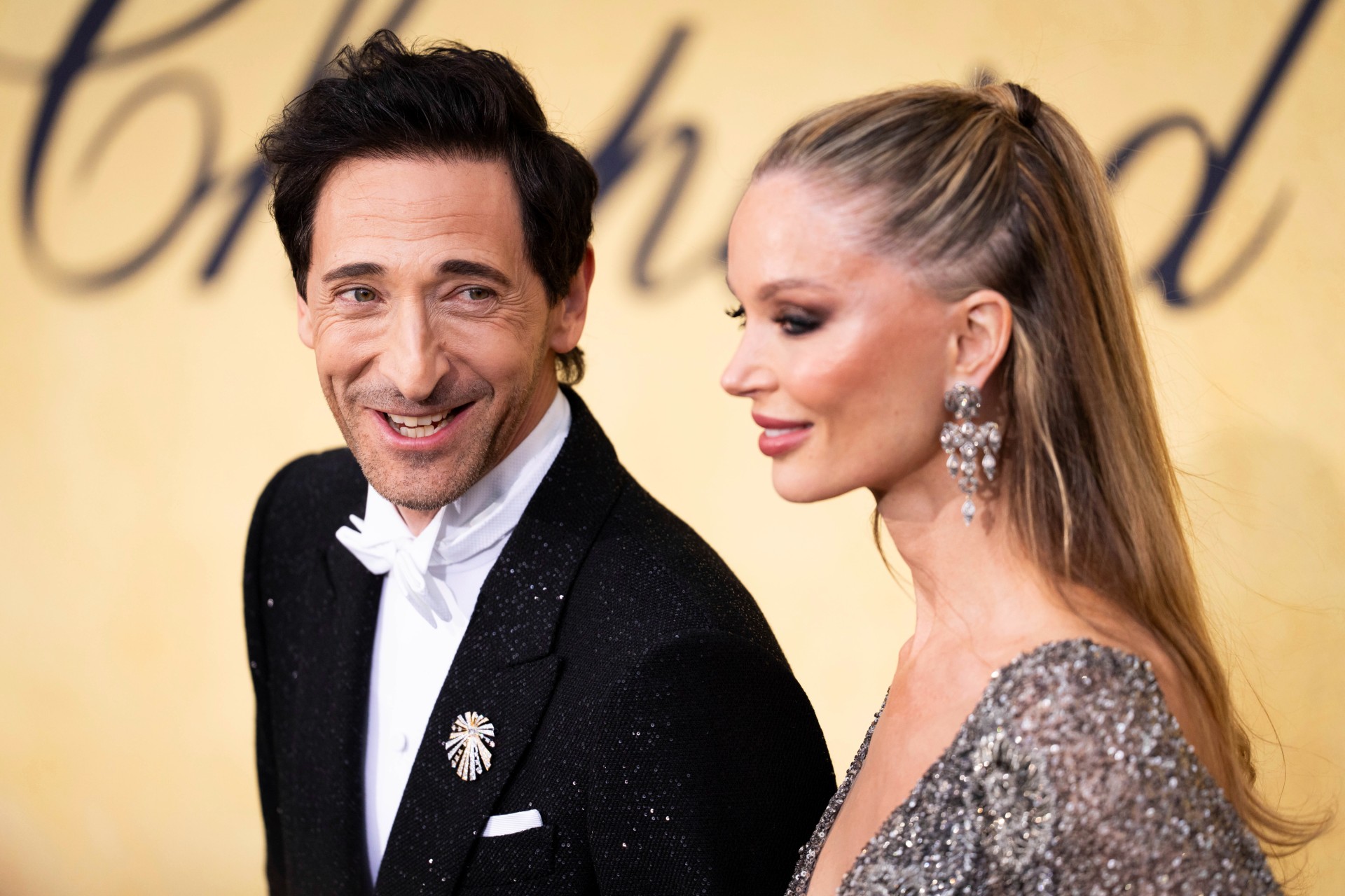 Adrien Brody, left, and Georgina Chapman pose for photographers upon arrival at the amfAR Cinema Against AIDS benefit at the Hotel du Cap-Eden-Roc, during the 78th Cannes international film festival, Cap d'Antibes, southern France, Thursday, May 22, 2025. (Photo by Scott A Garfitt/Invision/AP) France Cannes 2025 amfAR Arrivals