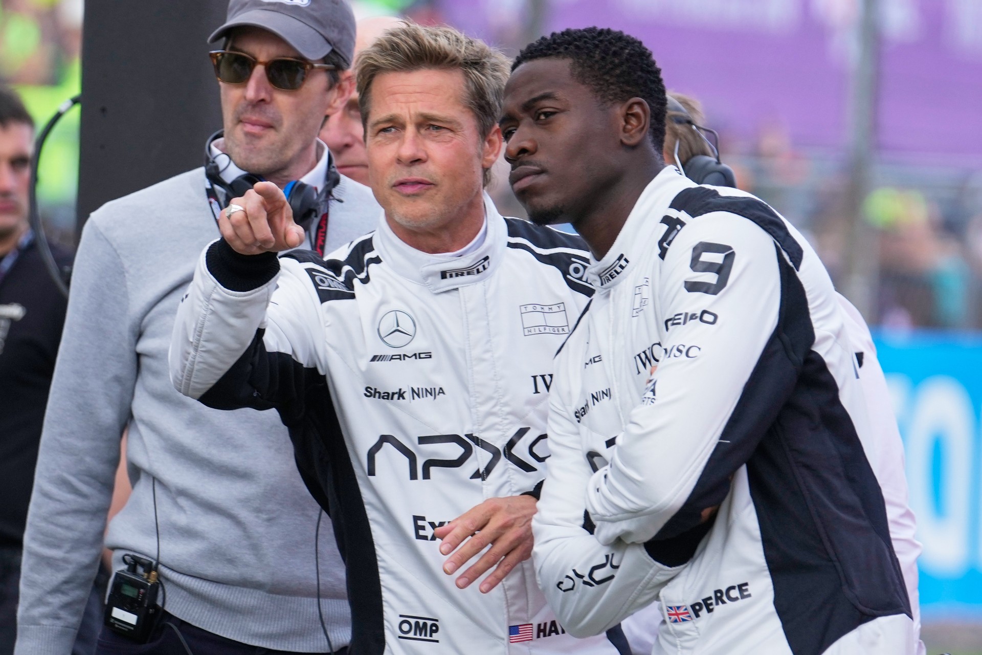 FILE - Actors Brad Pitt, left, and Damson Idris appear on the grid before the British Formula One Grand Prix race at the Silverstone racetrack, Silverstone, England, on July 9, 2023, for the filming of "F1." (AP Photo/Luca Bruno, File) Film-Summer Preview