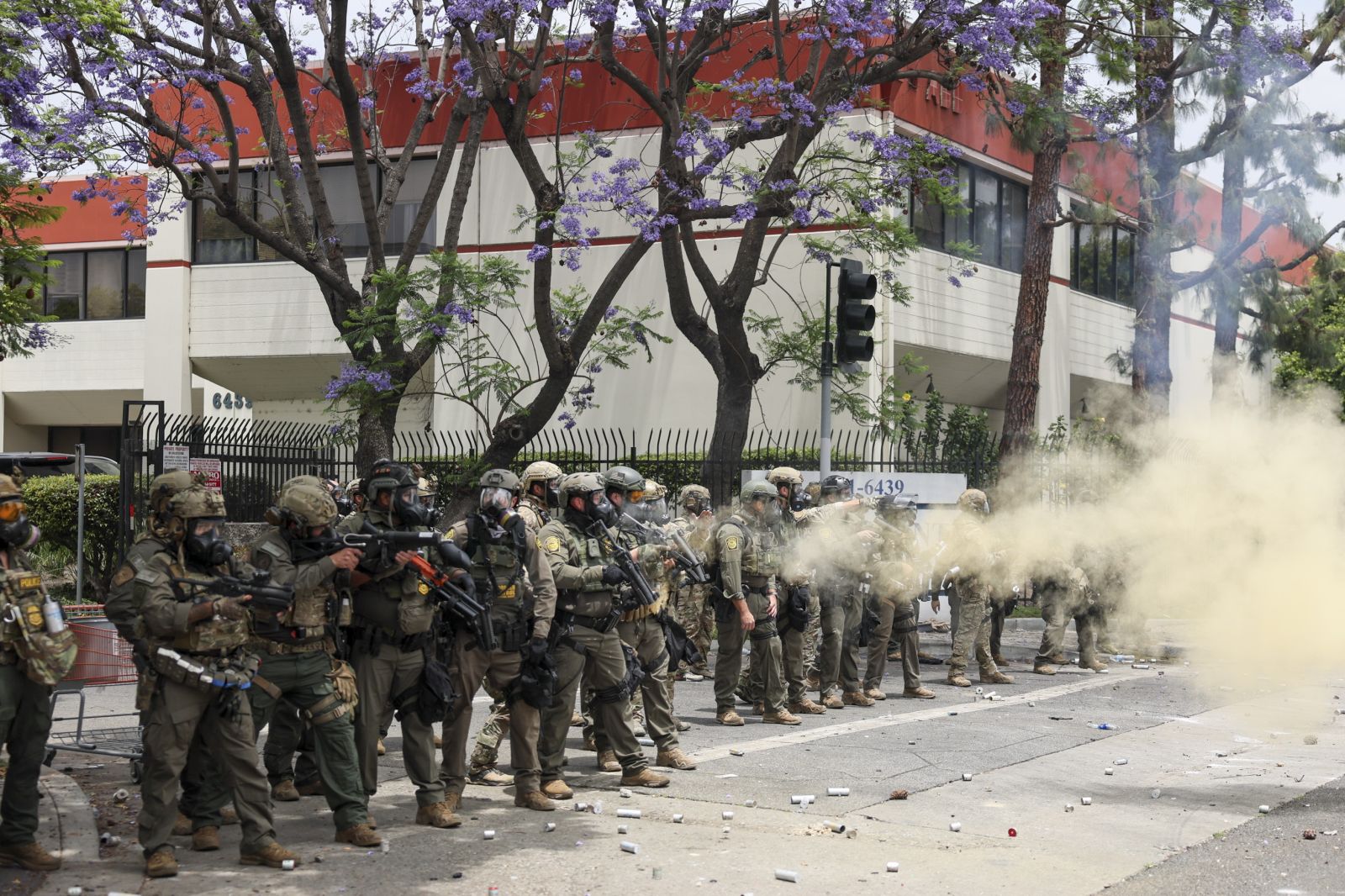 epa12163076 Federal agents fire flash-bang smoke grenades at protestors near a Home Depot after a raid was conducted by Immigration and Customs Enforcement (ICE) in Paramount, California, USA, 07 June 2025. This comes the day after federal immigration authorities arrested more than 40 people across Los Angeles, as protesters gathered outside a federal detention center.  EPA/ALLISON DINNER