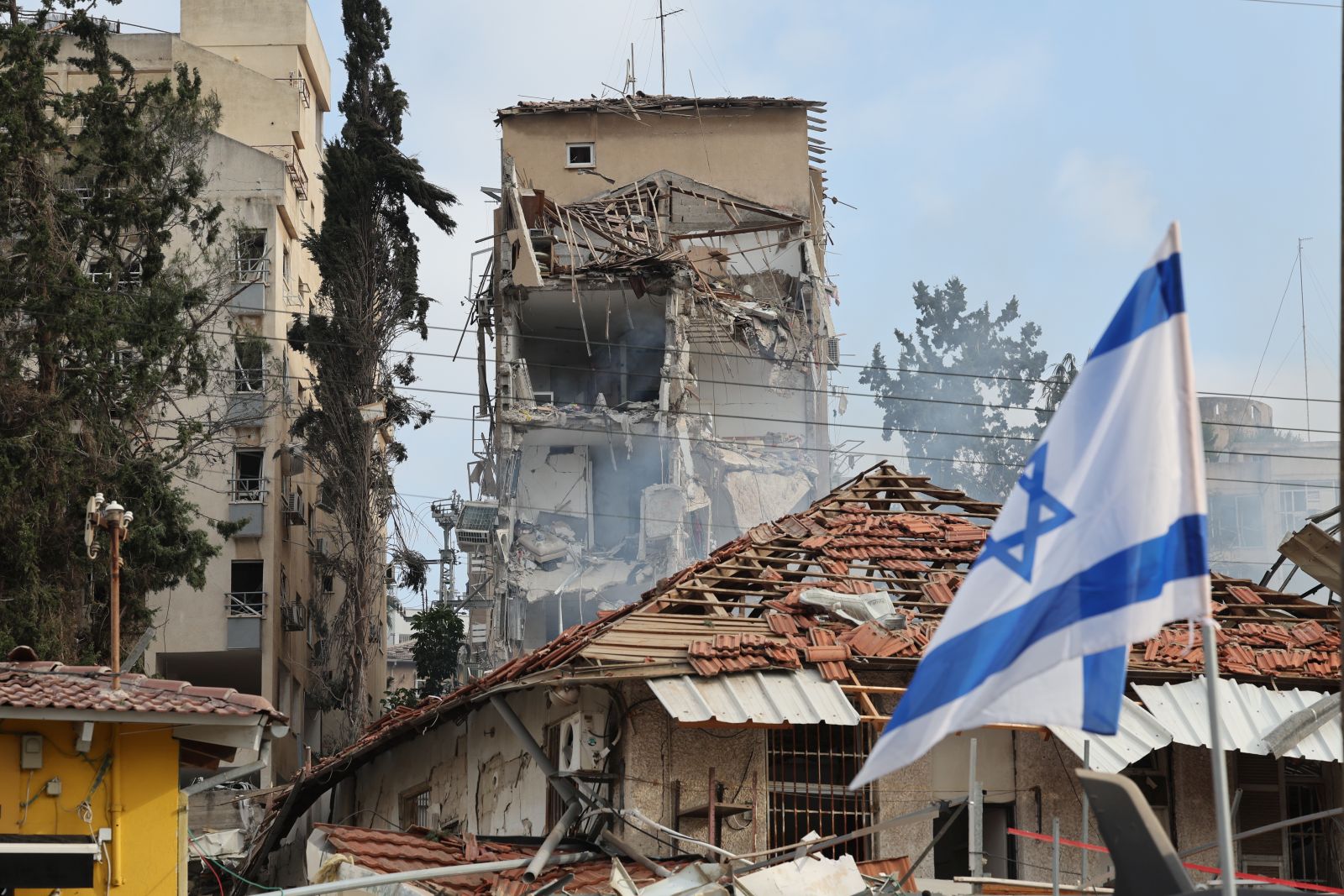 epa12176678 Israeli rescue teams work at the site of a damaged residential area after Iranian ballistic missiles hit Rehovot, central Israel, 15 June 2025. Iran launched a barrage of ballistic missiles at Israel overnight in retaliation for Israeli airstrikes on Iranian targets. Magen David Adom (MDA), Israel's national emergency services, reported at least six killed and dozens injured, including two in critical condition.  EPA/ABIR SULTAN