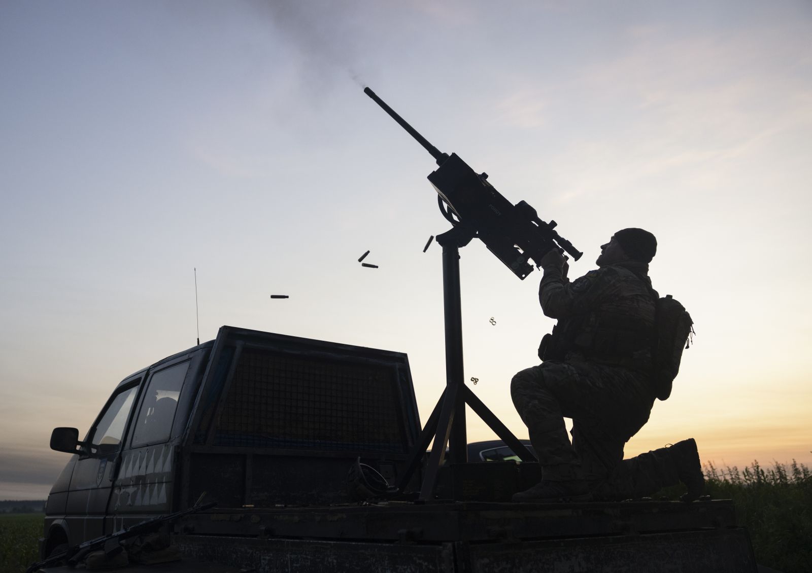 epa12180585 A Ukrainian serviceman of a unit of the Volunteer Formation of the United Territorial Community (DFTG) shoots at drones flying towards Kyiv, Ukraine, 17 June 2025. The volunteers are firing with a Browning M2 machine gun and a Kalashnikov rifle and shot down at least one target during the night, the DFTG said. At least 14 people died and more than 60 were injured in Kyiv after Russia launched a large-scale combined attack with at least 32 missiles and nearly 440 drones across Ukraine, according to the State Emergency Service.  EPA/STAS KOZLIUK