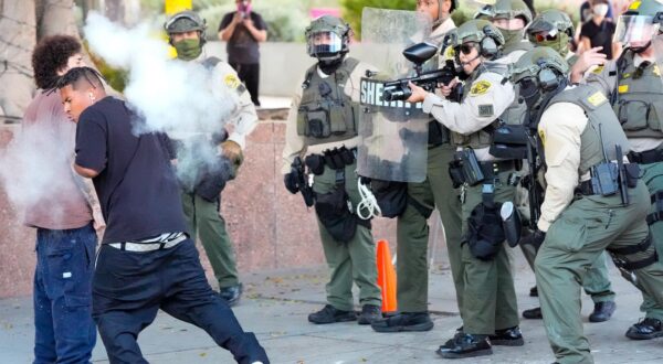 Police officers fire on a protestor after he threw a tear gas cannister at them during demonstrations over President Donald Trumps immigration policies. Trump has sent the California National Guard and U.S. Marines to Los Angeles City Hall over the objection of the governor and mayor. (Photo by Jen Golbeck / SOPA Images/Sipa USA) Photo: SOPA Images/SIPA USA