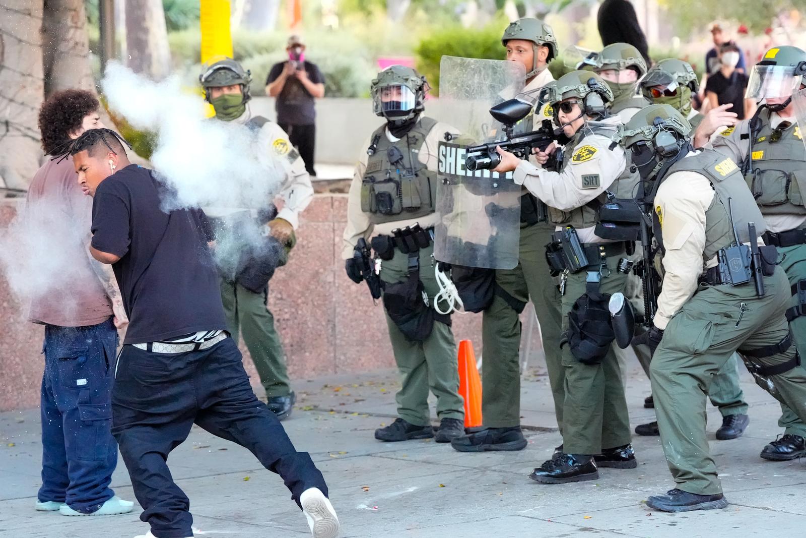 Police officers fire on a protestor after he threw a tear gas cannister at them during demonstrations over President Donald Trumps immigration policies. Trump has sent the California National Guard and U.S. Marines to Los Angeles City Hall over the objection of the governor and mayor. (Photo by Jen Golbeck / SOPA Images/Sipa USA) Photo: SOPA Images/SIPA USA