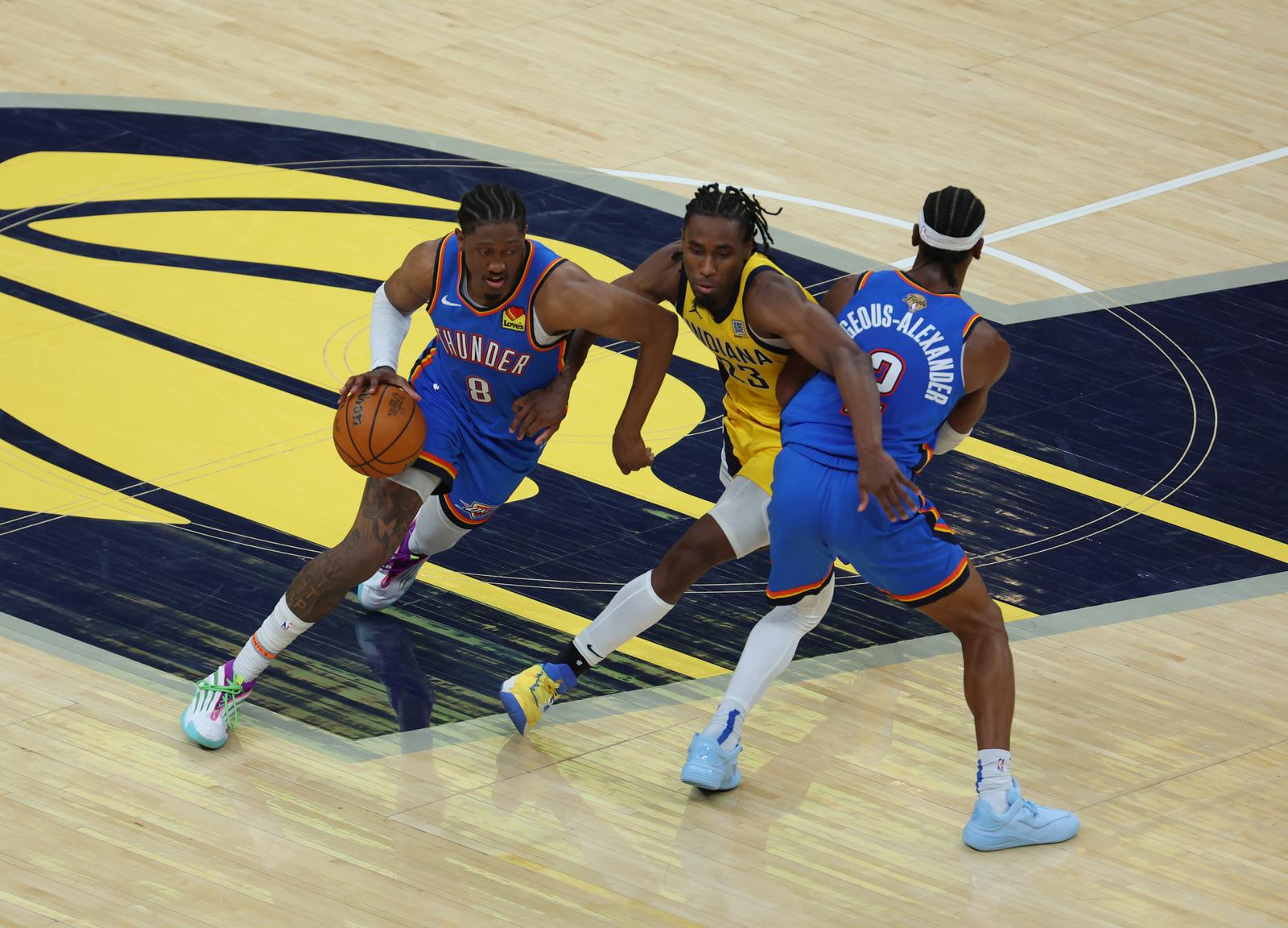 Jun 13, 2025; Indianapolis, Indiana, USA; Oklahoma City Thunder forward Jalen Williams (8) drives to the hoop as Oklahoma City Thunder guard Shai Gilgeous-Alexander (2) blocks Indiana Pacers forward Aaron Nesmith (23) during the fourth quarter of game four of the 2025 NBA Finals at Gainbridge Fieldhouse. Mandatory Credit: Trevor Ruszkowski-Imagn Images/Sipa USA Photo: Imagn Images/SIPA USA