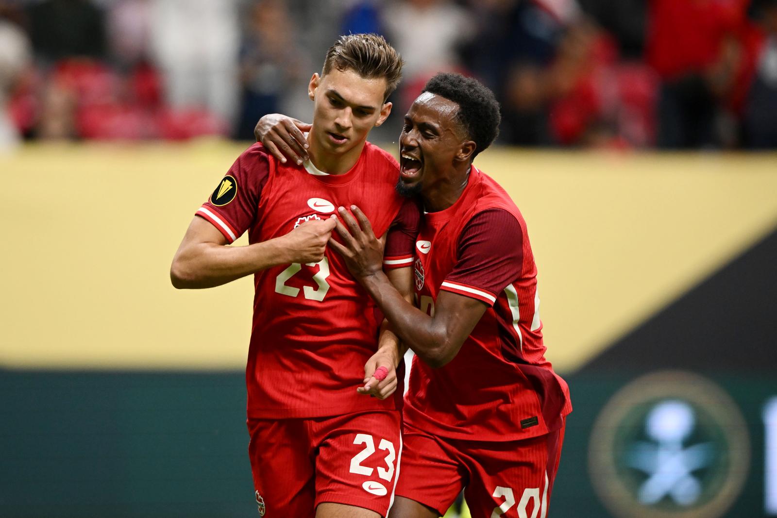 Jun 17, 2025; Vancouver, British Columbia, CAN; Canada defender Niko Sigur (23) celebrates with defender Ali Ahmed (20) after scoring a goal against Honduras in the first half during a group stage match of the 2025 Gold Cup at BC Place. Mandatory Credit: Anne-Marie Sorvin-Imagn Images/Sipa USA Photo: Imagn Images/SIPA USA