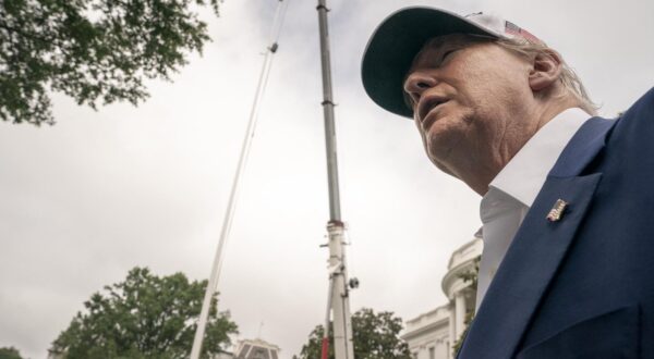 U.S. President Donald Trump looks back at workers as they install a new flag pole on the South Lawn at the White House in Washington, DC on Wednesday, June 18, 2025. Photo by Ken Cedeno/Pool/ABACAPRESS.COM Photo: Pool/ABACA/ABACA