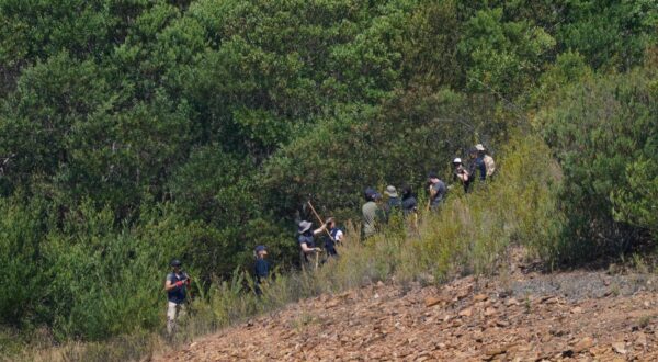 Personnel at Barragem do Arade reservoir, in the Algave, Portugal, as searches continue as part of the investigation into the disappearance of Madeleine McCann. The area is around 50km from Praia da Luz where Madeleine went missing in 2007. Picture date: Thursday May 25, 2023. Photo: Yui Mok/PRESS ASSOCIATION