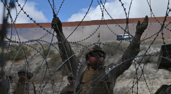 A member of the US Marine Corps installing concertina wire along the US-Mexico border wall in San Diego, California, seen from Tijuana, Mexico in between the San Diego-Tijuana border fences of Colonia Libertad on Thursday, February 06, 2025. The Defense Department deployed 1,600 active-duty troops to the border during US President Donald Trumps first week in office. (Photo by Carlos Moreno/Sipa USA)  Photo: Carlos Moreno/SIPA USA