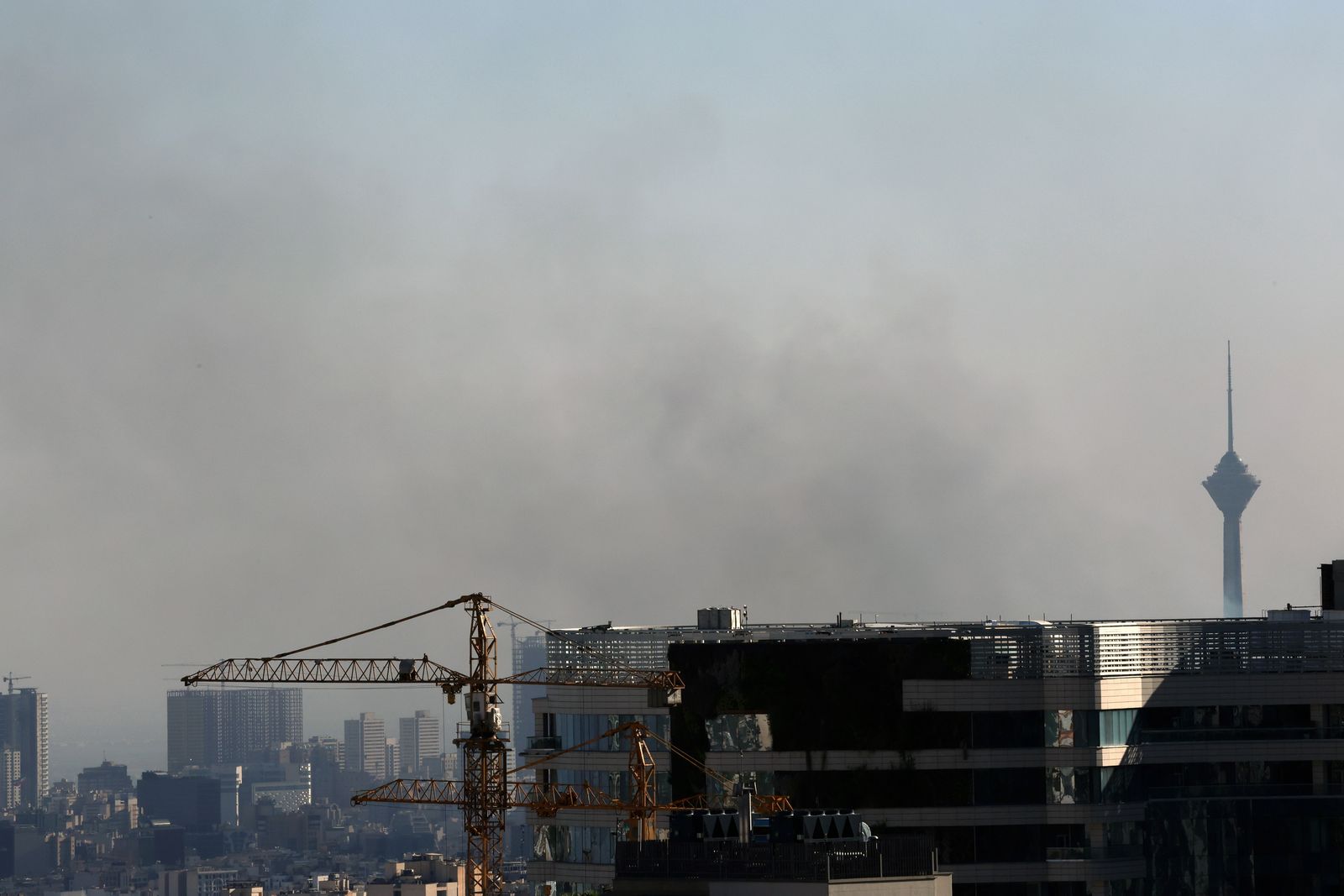 epa12183876 Smoke rises near the Milad Tower following an Israeli airstrike on Tehran, Iran, 18 June 2025. Israel and Iran have been exchanging fire since Israel launched strikes across Iran on 13 June 2025 as part of Operation 'Rising Lion.'  EPA/ABEDIN TAHERKENAREH
