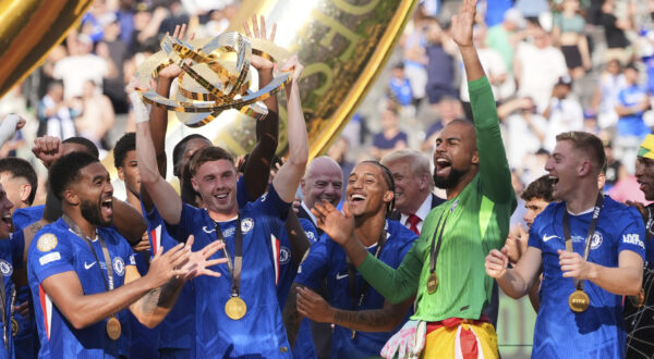 Chelsea's Cole Palmer (10) lifts the trophy following the Club World Cup final soccer match between Chelsea and PSG in East Rutherford, N.J., Sunday, July 13, 2025. (AP Photo/Seth Wenig)
