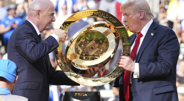 President Donald Trump, right, and FIFA President Gianni Infantino carry the championship trophy at the conclusion of the Club World Cup final soccer match at MetLife Stadium in East Rutherford, N.J., Sunday, July 13, 2025. (AP Photo/Jacquelyn Martin)