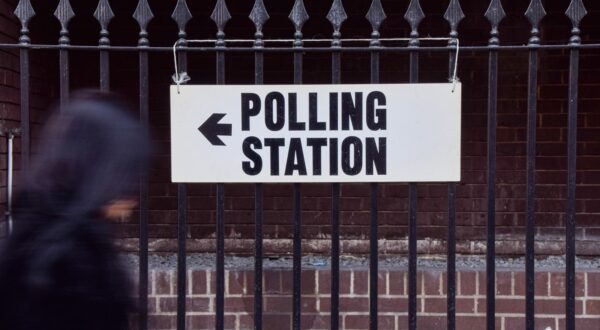 A person walks past a sign at a polling station in Central London as polls open in the UK general election. (Photo by Vuk Valcic / SOPA Images/Sipa USA) Photo: SOPA Images/SIPA USA
