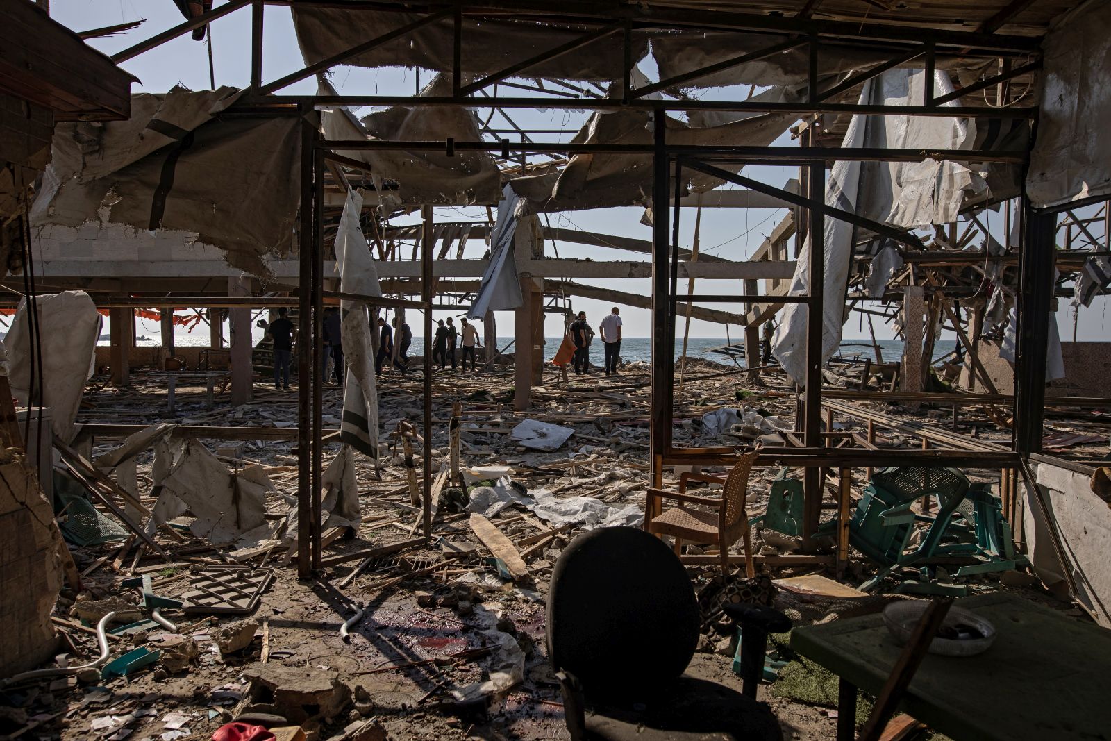 epa12206626 Palestinians inspect the site of an Israeli airstrike that targeted Al-Baqa Cafe, located on the seafront of Gaza City in the western part of the city, 30 June 2025. According to the Gaza Ministry of Health, the strike resulted in the death of 24 Palestinians.  EPA/HAITHAM IMAD