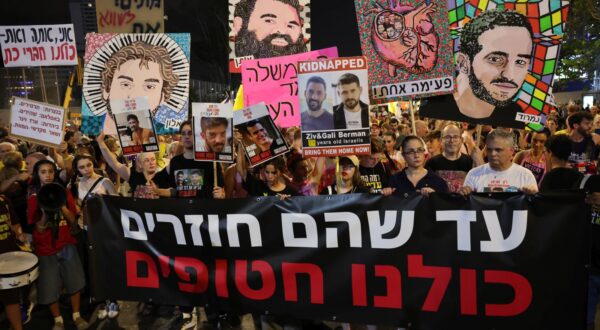 epa12234425 Families of Israeli hostages held by Hamas in Gaza hold a banner with 'until they will return we are all hostages' written in Hebrew during protest outside the Kirya military headquarters in Tel Aviv, Israel, 12 July 2025. According to the Israeli army (IDF) spokesperson, around 50 Israeli hostages remain in captivity in the Gaza Strip, including the bodies of at least 30 confirmed dead.  EPA/ABIR SULTAN