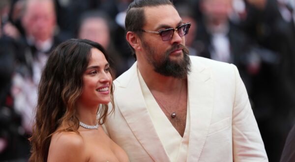 Adria Arjona, left, and Jason Momoa pose for photographers upon arrival at the premiere of the film 'Highest 2 Lowest' at the 78th international film festival, Cannes, southern France, Monday, May 19, 2025. (Photo by Lewis Joly/Invision/AP) France Cannes 2025 Highest 2 Lowest Red Carpet