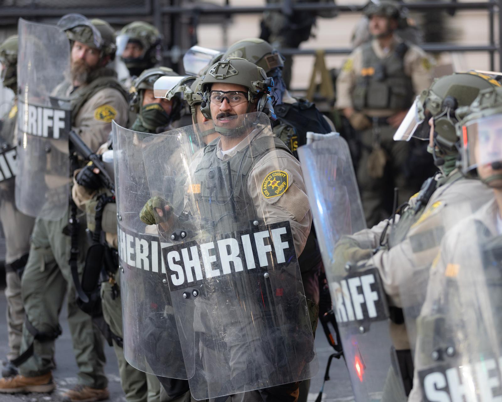 Los Angeles County Sheriffs deputies in tactical gear stand in formation behind riot shields in preparation for crowd control measures during an anti-ICE protest. A demonstration staged as part of a national day of action drew hundreds of protesters who marched against ICE and police violence in downtown Los Angeles (Photo by Lela Edgar / SOPA Images/Sipa USA) Photo: SOPA Images/SIPA USA