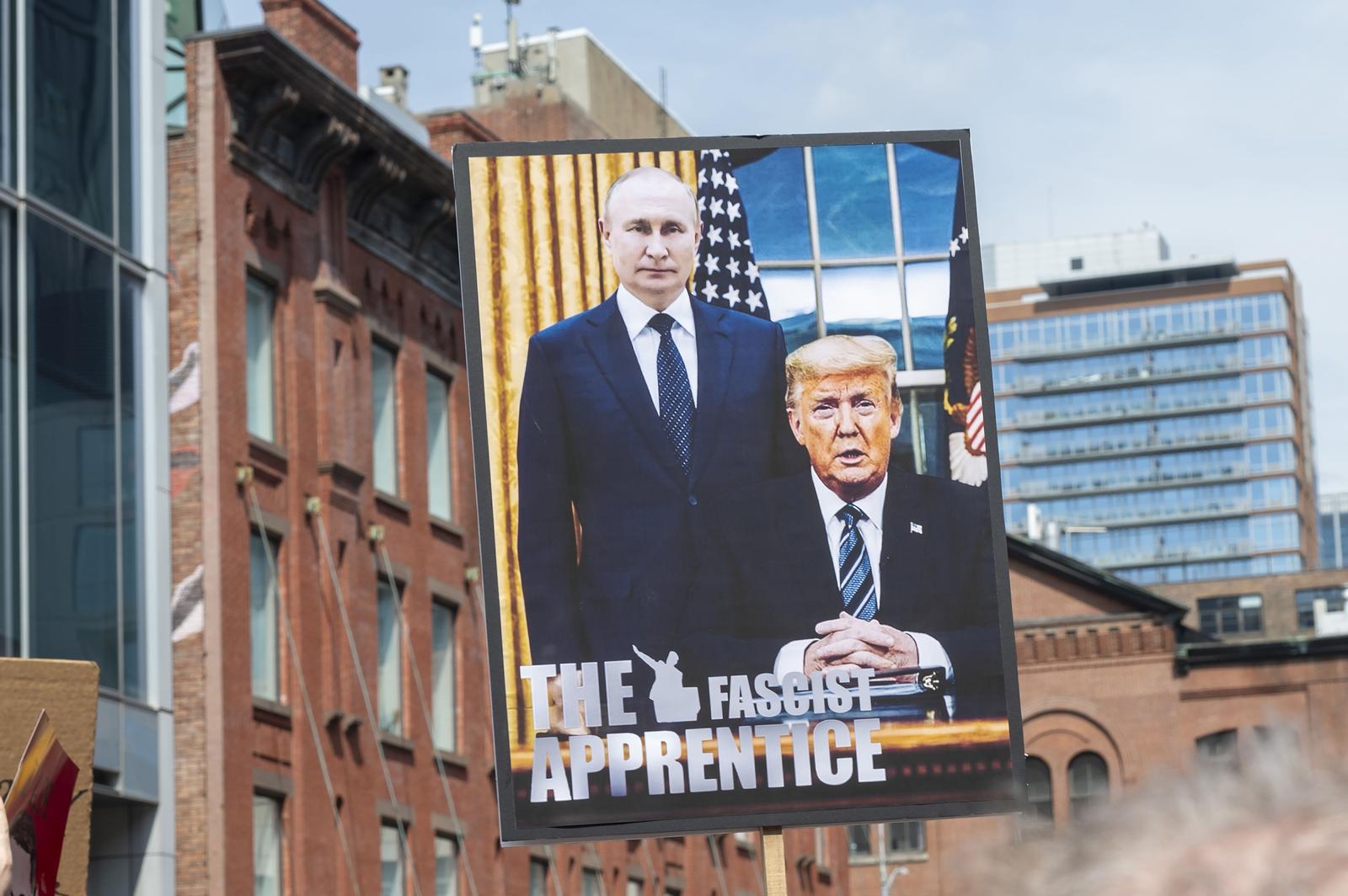 A placard "The Fascist Apprentice" of President Trump and President Putin seen during a Tesla Takedown rally outside the Manhattan Tesla showroom. The electric-vehicle maker has been hit by headline-grabbing protests and vandalism in recent weeks, part of a backlash to Chief Executive Officer Elon Musk's role in the Trump administrations efforts to slash the federal government. (Photo by Ron Adar / SOPA Images/Sipa USA) Photo: SOPA Images/SIPA USA