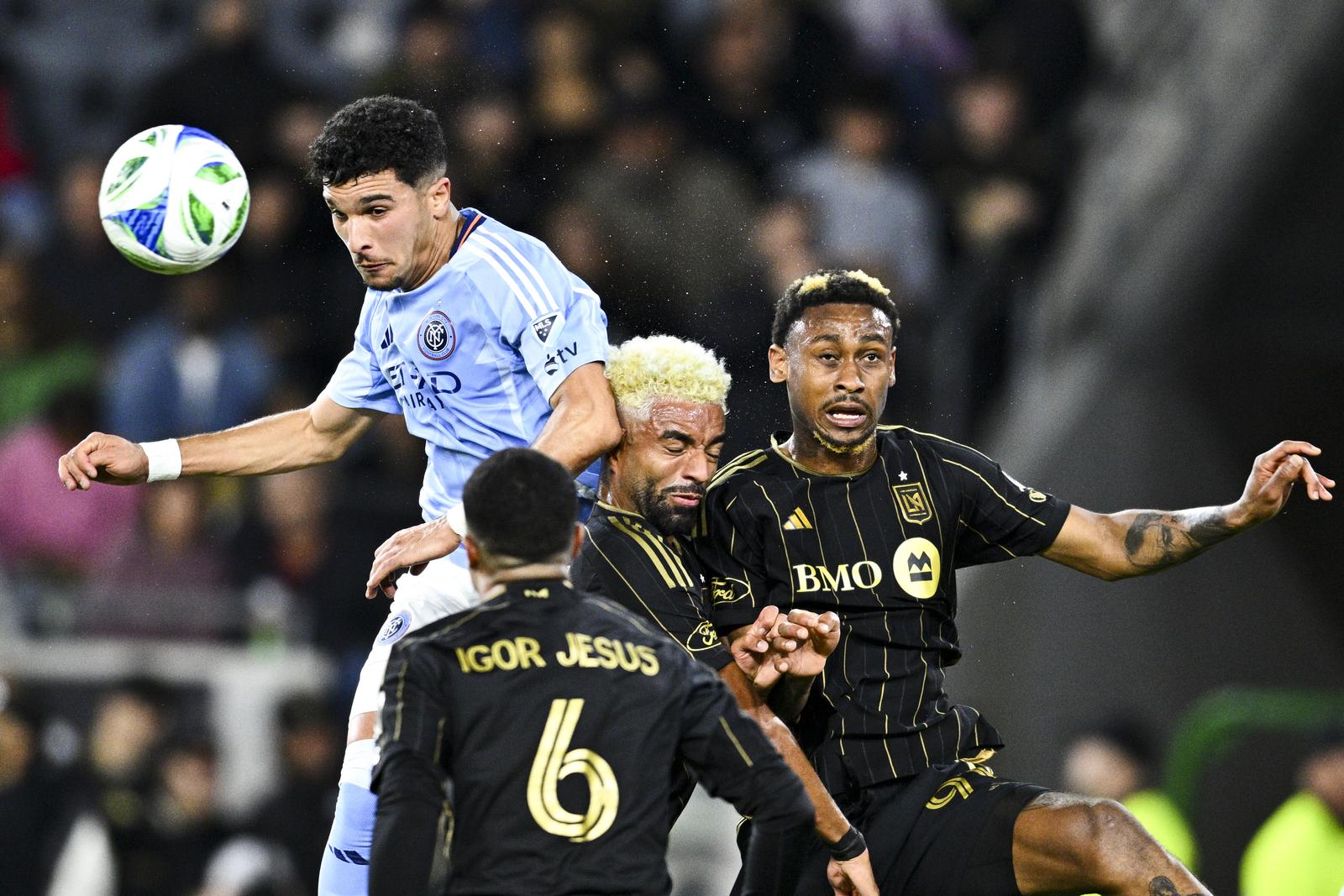Mar 1, 2025; Los Angeles, California, USA; New York City FC forward Monsef Bakrar (9) battles for the header against  Los Angeles FC midfielder Timothy Tillman (11) and defender Nkosi Tafari (91) during the first half at BMO Stadium. Mandatory Credit: Kelvin Kuo-Imagn Images/Sipa USA Photo: Imagn Images/SIPA USA