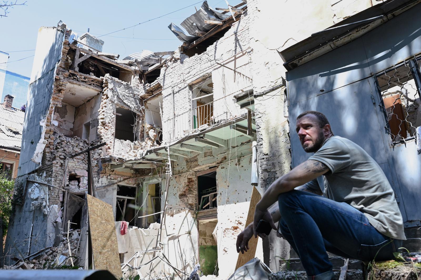 A man squats by a building affected by the combined Russian attack on Lviv, Ukraine, July 12, 2025. The Russian strike damaged residential buildings, a kindergarten, dozens of cars, and caused the roof of a non-residential building to catch fire. At least nine people are injured, including an 11-year-old boy. (Photo by Anastasiia Smolienko/Ukrinform) (Photo by Ukrinform/Ukrinform/Sipa USA) Photo: UKRINFORM/SIPA USA