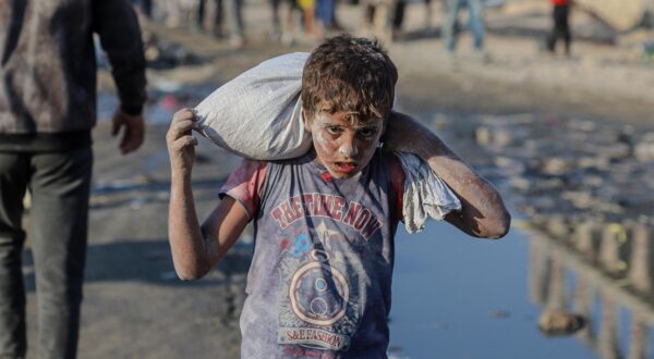 Palestinians carry humanitarian aid received through the Zikim crossing as they return to their families near the Al-Sudaniya area in northern Gaza, Palestine on July 26 2025, reflecting the ongoing humanitarian crisis in the Strip. Photo by Ramez Habboub/ABACAPRESS.COM Photo: Habboub Ramez/ABACA/ABACA