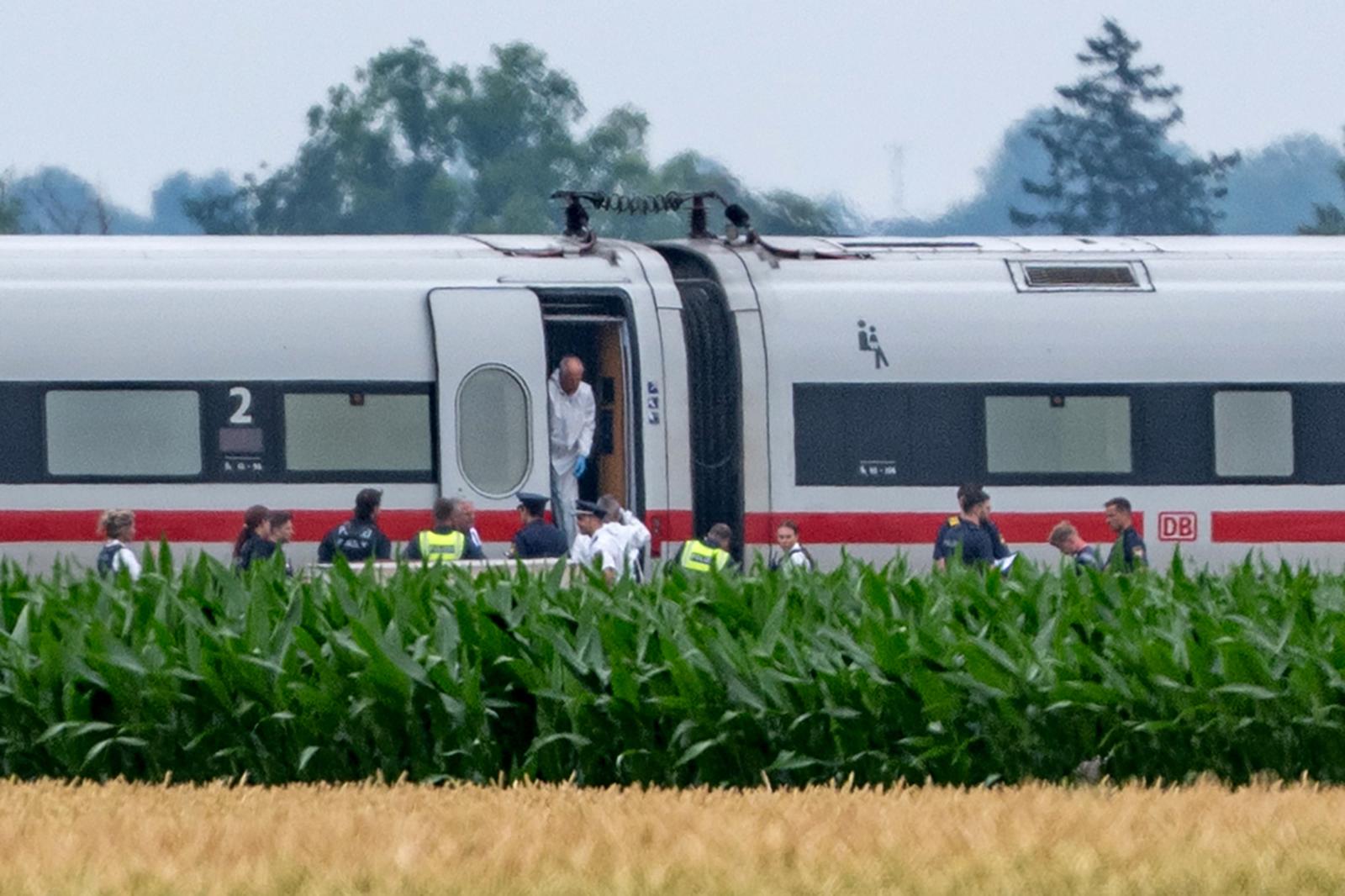 dpatop - 03 July 2025, Bavaria, Straßkirchen: Police and forensics are investigating an ICE train in which a man attacked several passengers in Lower Bavaria. The suspected perpetrator has been arrested. He had used dangerous objects in the attack. Photo: Armin Weigel/dpa Photo: Armin Weigel/DPA