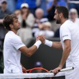 Flavio Cobolli and Marin Cilic shake hands after their match on day eight of the 2025 Wimbledon Championships at the All England Lawn Tennis and Croquet Club, London. Picture date: Monday July 7, 2025. Photo: Jordan Pettitt/PRESS ASSOCIATION