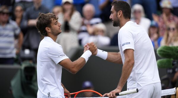 Flavio Cobolli and Marin Cilic shake hands after their match on day eight of the 2025 Wimbledon Championships at the All England Lawn Tennis and Croquet Club, London. Picture date: Monday July 7, 2025. Photo: Jordan Pettitt/PRESS ASSOCIATION