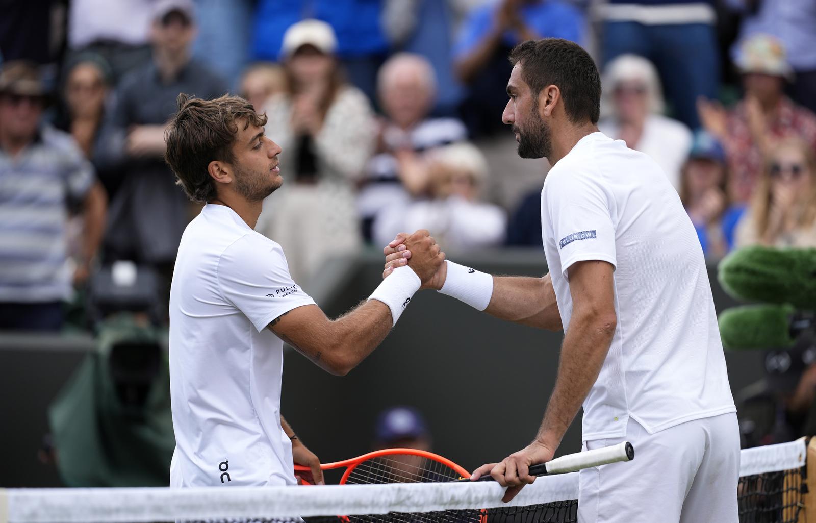 Flavio Cobolli and Marin Cilic shake hands after their match on day eight of the 2025 Wimbledon Championships at the All England Lawn Tennis and Croquet Club, London. Picture date: Monday July 7, 2025. Photo: Jordan Pettitt/PRESS ASSOCIATION