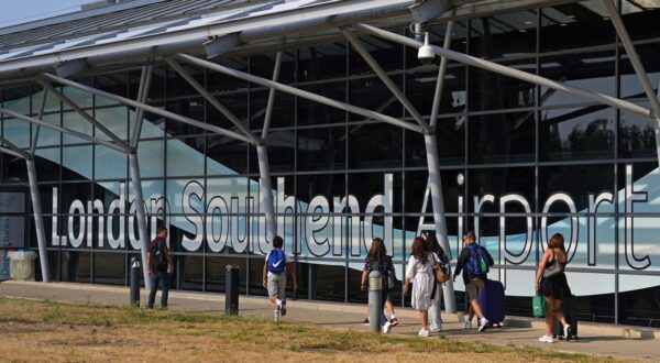 Passengers outside the terminal building at Southend Airport in Essex, where a 12-metre plane crashed shortly after take off on Sunday afternoon. Picture date: Monday July 14, 2025. Photo: Joe Giddens/PRESS ASSOCIATION