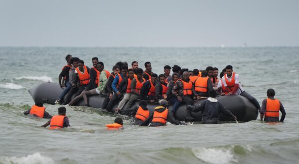 File photo dated 17/7/2025 of people thought to be migrants scramble to board a small boat near Wimereux in France. The first wave of sanctions aimed at key figures in people-smuggling gangs have come into force in a bid to hit those involved in assisting illegal immigration to the UK. They target 25 individuals and entities including a small boat supplier in Asia and gang leaders based in the Balkans and North Africa. Issue date: Wednesday July 23, 2025. Photo: Gareth Fuller/PRESS ASSOCIATION