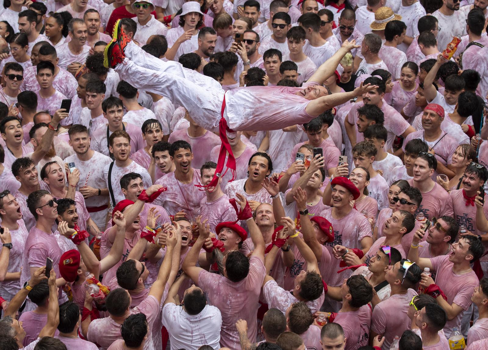 A reveler is tossed by the crowd as the partying begins in the Town Hall square in Pamplona, northern Spain, on July 5, 2025 as the 8-day Fiesta de San Fermín begins. The 8-day festival was made famous by American novelist Ernest Hemingway in his 1926 novel "The Sun Also Rises." His novel speaks of "the lost generation'' after World War I and includes the famous running with the bulls and bullfighting. The fiesta opened with political overtones including calls for Independence for the Basque Country and "Free Palestine." Photo by Jim Hollander/UPI Photo via Newscom Photo: JIM HOLLANDER/NEWSCOM
