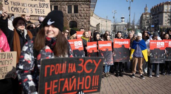 Protesters hold placards expressing their opinion during a rally denouncing corruption and calling for better funding of the Ukrainian armed forces in central Kyiv. The Russian invasion of Ukraine has been ongoing for more than two years, and a gloomy mood hangs over the country. On the battlefield, Ukrainian troops are running low on ammunition as they look for further Western help. (Photo by Oleksii Chumachenko / SOPA Images/Sipa USA) Photo: SOPA Images/SIPA USA