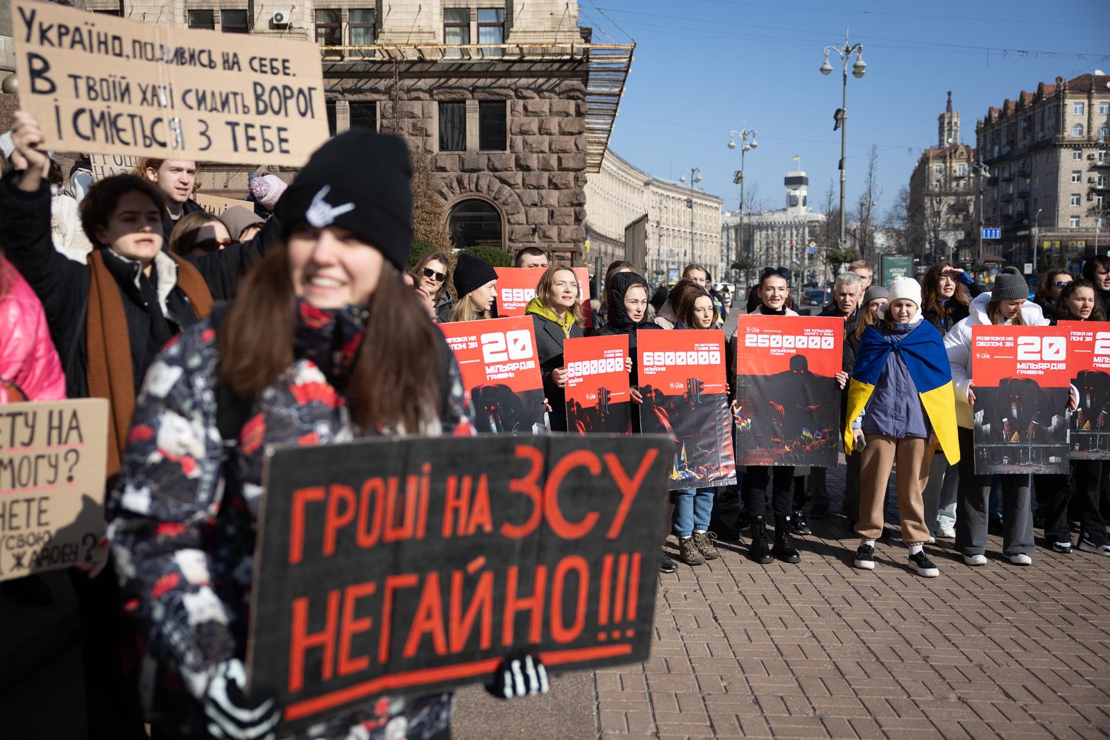 Protesters hold placards expressing their opinion during a rally denouncing corruption and calling for better funding of the Ukrainian armed forces in central Kyiv. The Russian invasion of Ukraine has been ongoing for more than two years, and a gloomy mood hangs over the country. On the battlefield, Ukrainian troops are running low on ammunition as they look for further Western help. (Photo by Oleksii Chumachenko / SOPA Images/Sipa USA) Photo: SOPA Images/SIPA USA