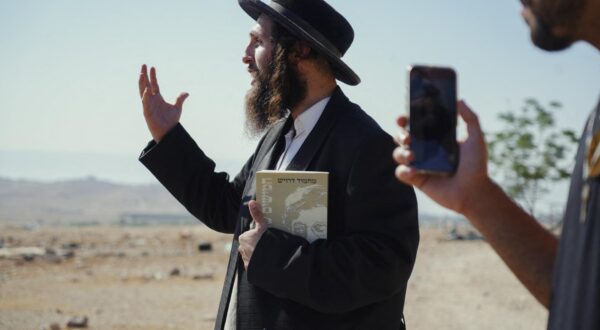 Yehonathan, an Israeli activist, stands near the Bedouin communities in the villages of Al-Muarrajat and Ras al-Ain in the Jordan Valley, occupied West Bank, on June 26, 2025. He came to provide a protective presence for Palestinian Bedouins who report regular harassment by settlers; in his hand, he holds a book by Palestinian poet Mahmoud Darwish. Photo by Khadija Toufik/Middle East Images/ABACAPRESS.COM Photo: Middle East Images/ABACA/ABACA