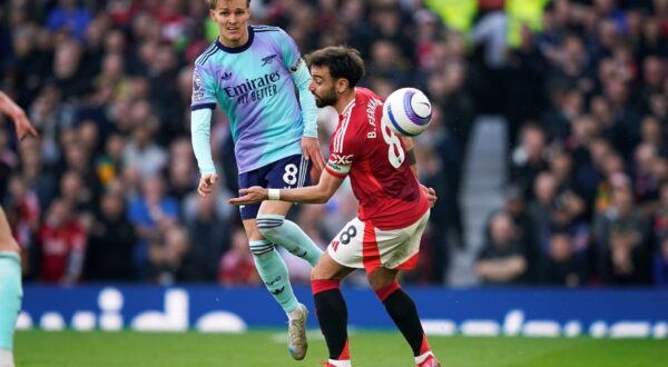 Arsenal's Martin Odegaard, left, and Manchester United's Bruno Fernandes compete for the ball during the English Premier League soccer match between Manchester United and Arsenal at Old Trafford stadium in Manchester, England, Sunday, March 9, 2025. (AP Photo/Dave Thompson) Britain Soccer Premier League
