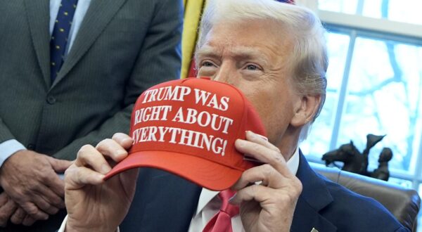 United States President Donald Trump holds a hat reading "Trump was right about everything" after signing Executive Orders in the Oval Office of the White House in Washington on January 23, 2025. 
Credit: Yuri Gripas / Pool via CNP/AdMedia Photo: CNP/AdMedia/NEWSCOM