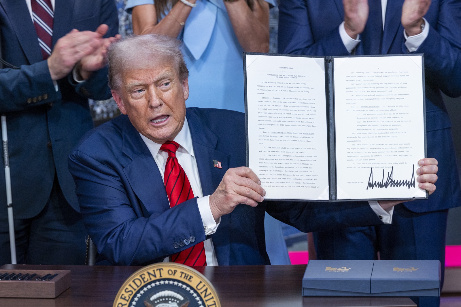 epa12285249 US President Donald J. Trump displays the executive order establishing an Olympic task force at the White House in Washington, DC, USA 05 August 2025. President Trump established a 2028 Los Angeles Olympic Games task force to ensure the event is “safe, seamless and historically successful.”  EPA/SHAWN THEW