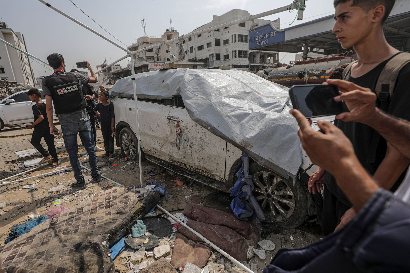 epa12293401 The damaged car of Al Jazeera journalist Anas Al-Sharif as Palestinians inspect the destroyed tent of the Al Jazeera team following an Israeli strike, outside the Al-Shifa Hospital in Gaza City, 11 August 2025. At least seven people, including five Al Jazeera media team members Anas Al-Sharif, Mohammed Qreiqeh, Ibrahim Zaher, Moamen Aliwa and Mohammed Noufal, were killed in an Israeli strike on their tent outside Gaza's Al-Shifa Hospital late 10 August 2025. The Israel Defense Forces (IDF) claimed direct responsibility for the attack.  EPA/MOHAMMED SABER