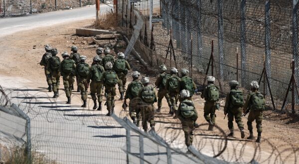 epa12252592 Israeli soldiers patrolling at the ceasefire line, near the Israeli-annexed Golan Heights village of Majdal Shams, 22 July 2025.  EPA/ATEF SAFADI