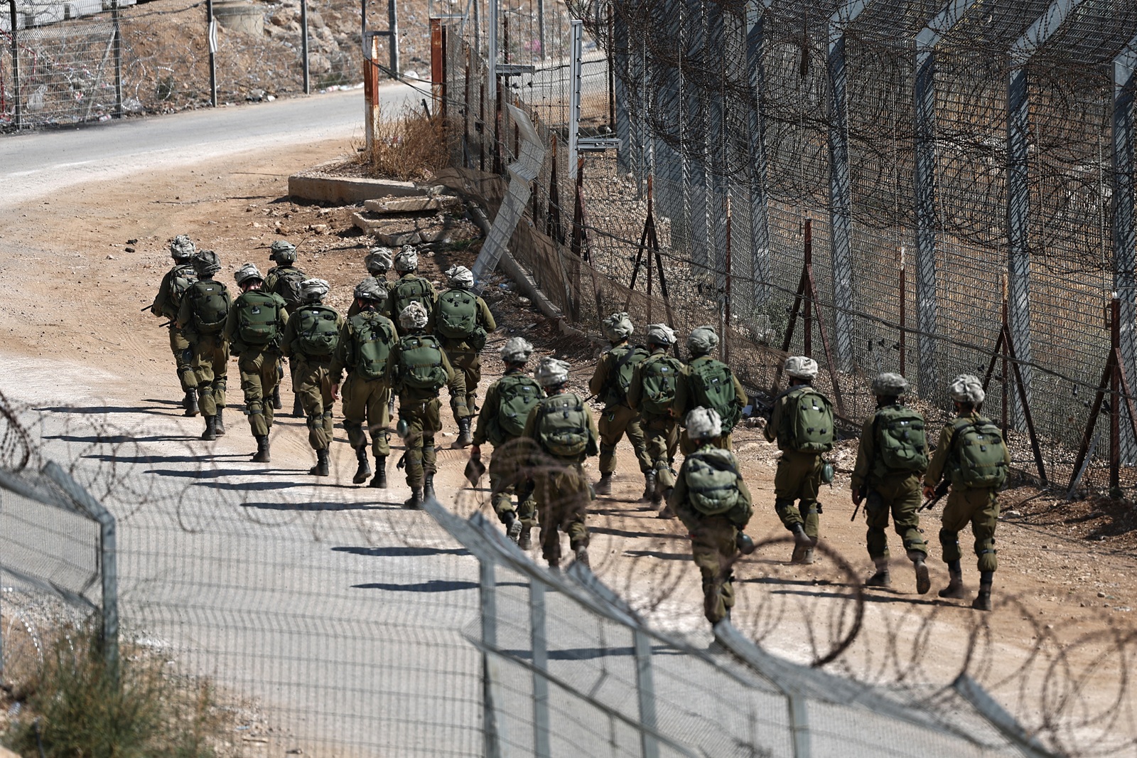 epa12252592 Israeli soldiers patrolling at the ceasefire line, near the Israeli-annexed Golan Heights village of Majdal Shams, 22 July 2025.  EPA/ATEF SAFADI
