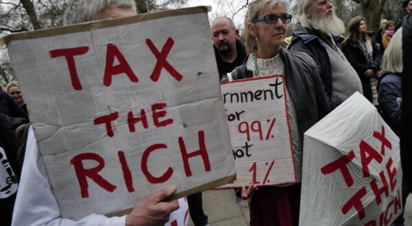 Protesters gather outside the UK Treasury in London for the Tax the Super-Rich Rally, demanding higher taxes on wealthy individuals and corporations. Organised by multiple advocacy groups, the demonstration calls for economic reforms to address wealth inequality and fund public services. Activists argue that the current tax system benefits the richest at the expense of ordinary citizens, urging policymakers to implement fairer fiscal policies. The protest forms part of a broader movement pushing for social and economic justice. (Photo by Joao Daniel Pereira/Sipa USA) Photo: Joao Daniel Pereira/SIPA USA