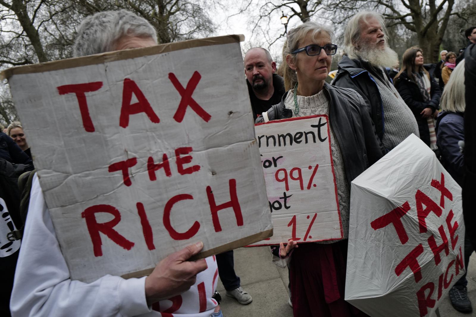 Protesters gather outside the UK Treasury in London for the Tax the Super-Rich Rally, demanding higher taxes on wealthy individuals and corporations. Organised by multiple advocacy groups, the demonstration calls for economic reforms to address wealth inequality and fund public services. Activists argue that the current tax system benefits the richest at the expense of ordinary citizens, urging policymakers to implement fairer fiscal policies. The protest forms part of a broader movement pushing for social and economic justice. (Photo by Joao Daniel Pereira/Sipa USA) Photo: Joao Daniel Pereira/SIPA USA