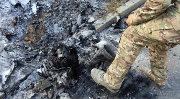 A man in a camouflage uniform stands by an engine after a Russian missile and drone strike, Kyiv, Ukraine, on July 21, 2025. In the early hours of Monday, July 21, Russian troops attacked the Ukrainian capital with drones and missiles, killing one person and injuring nine others, including a 15-year-old girl. (Photo by Oleksandr Klymenko/Ukrinform) (Photo by Ukrinform/Ukrinform/Sipa USA) Photo: UKRINFORM/SIPA USA